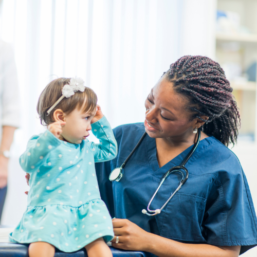 Doctor talking with a small child.