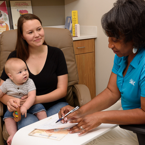  Mom with 9 month old child talking to WIC counselor